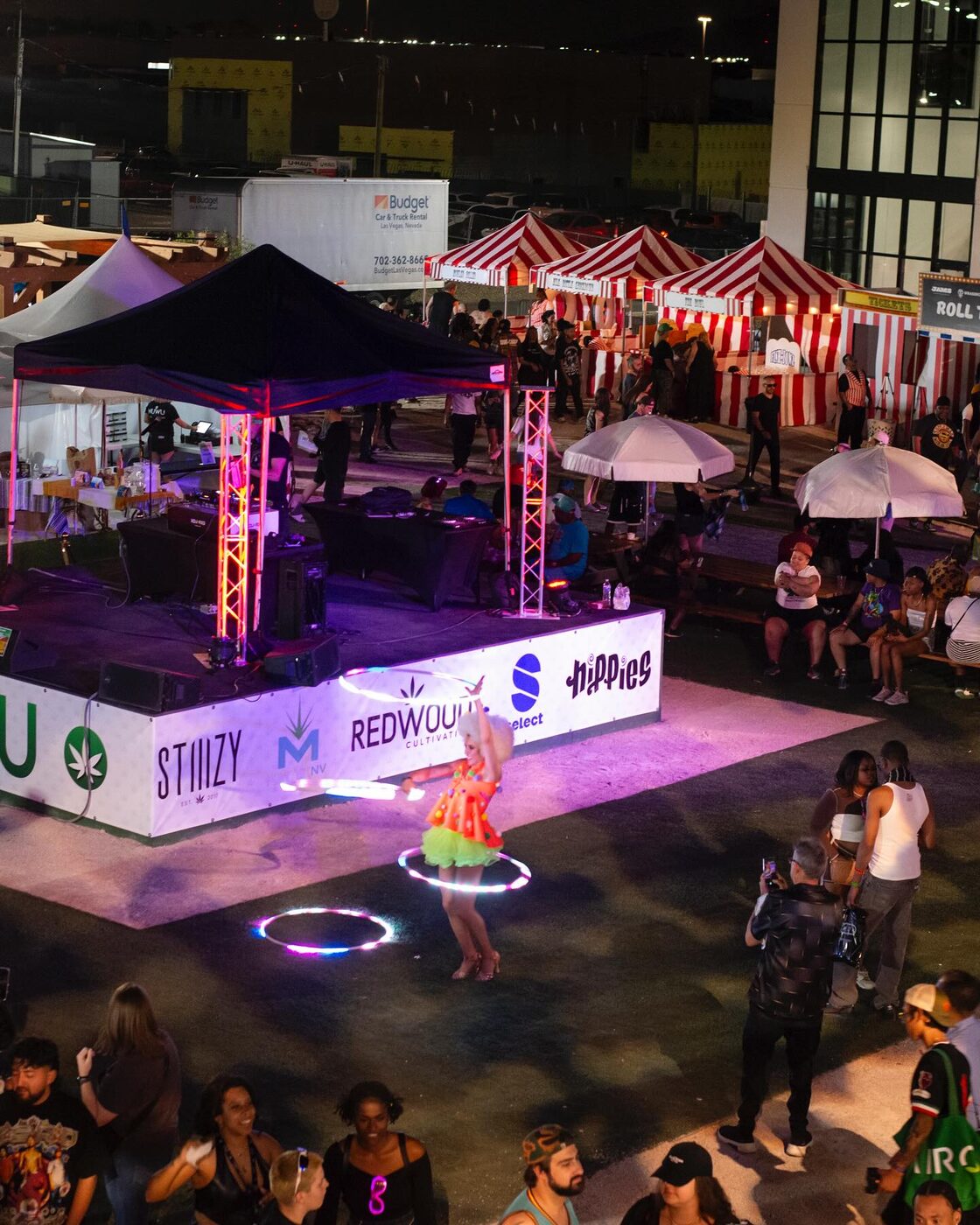 The fair after dark — neon over the NuWu courtyard crowd