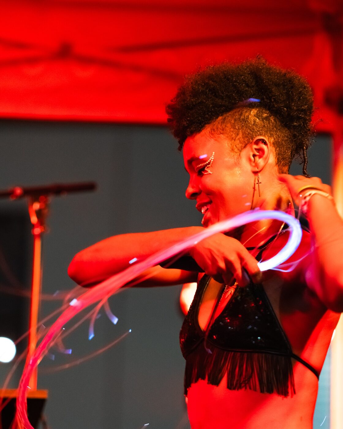 An LED-hoop performer lights up the night