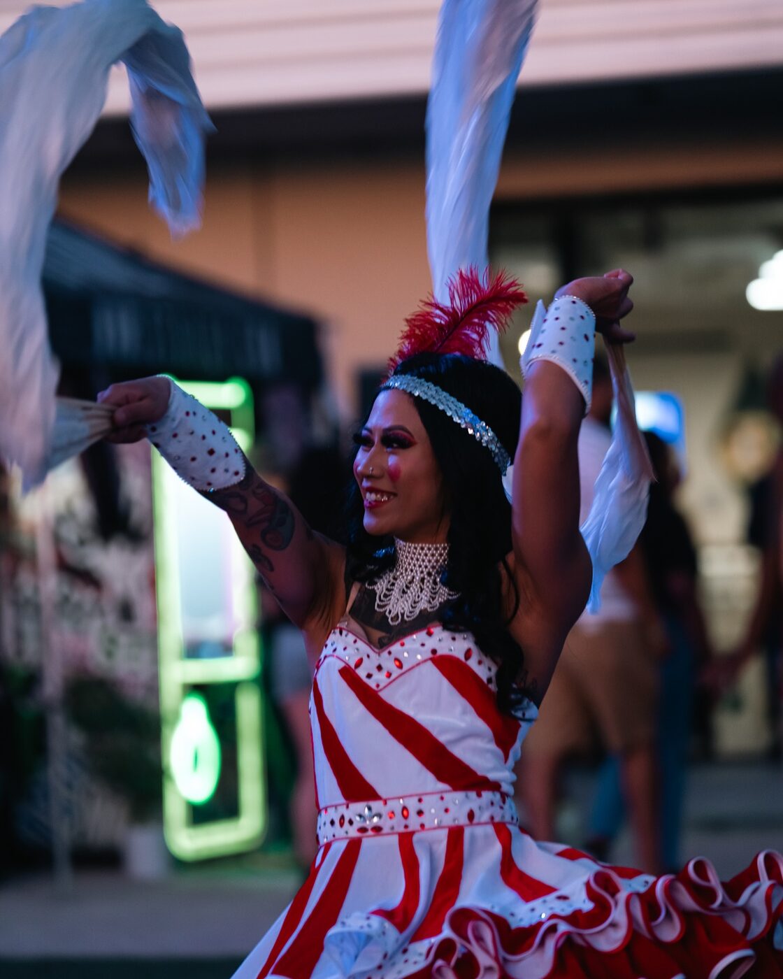A carnival dancer in red-and-white stripes