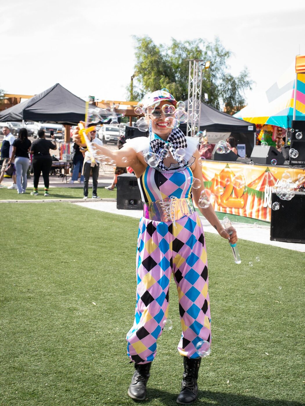 A harlequin performer works the courtyard in a diamond costume