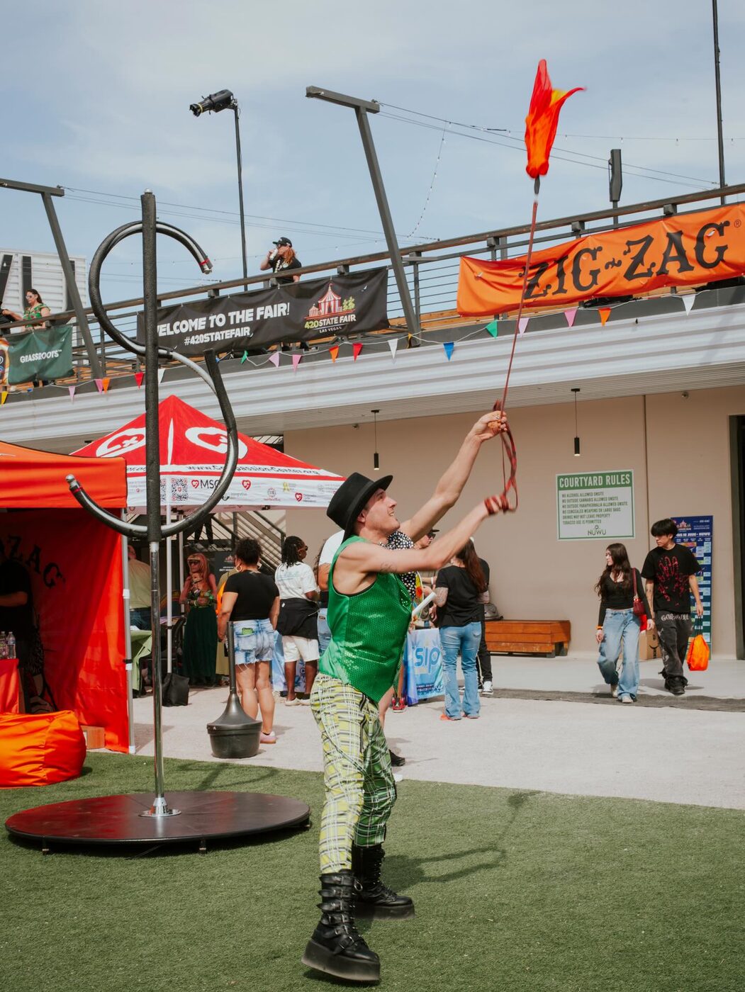 Guests dance at a vendor booth on the midway