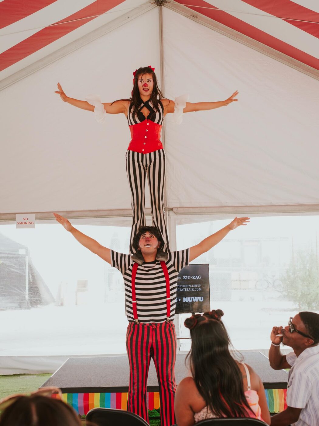 Acrobats balance for the crowd in the courtyard