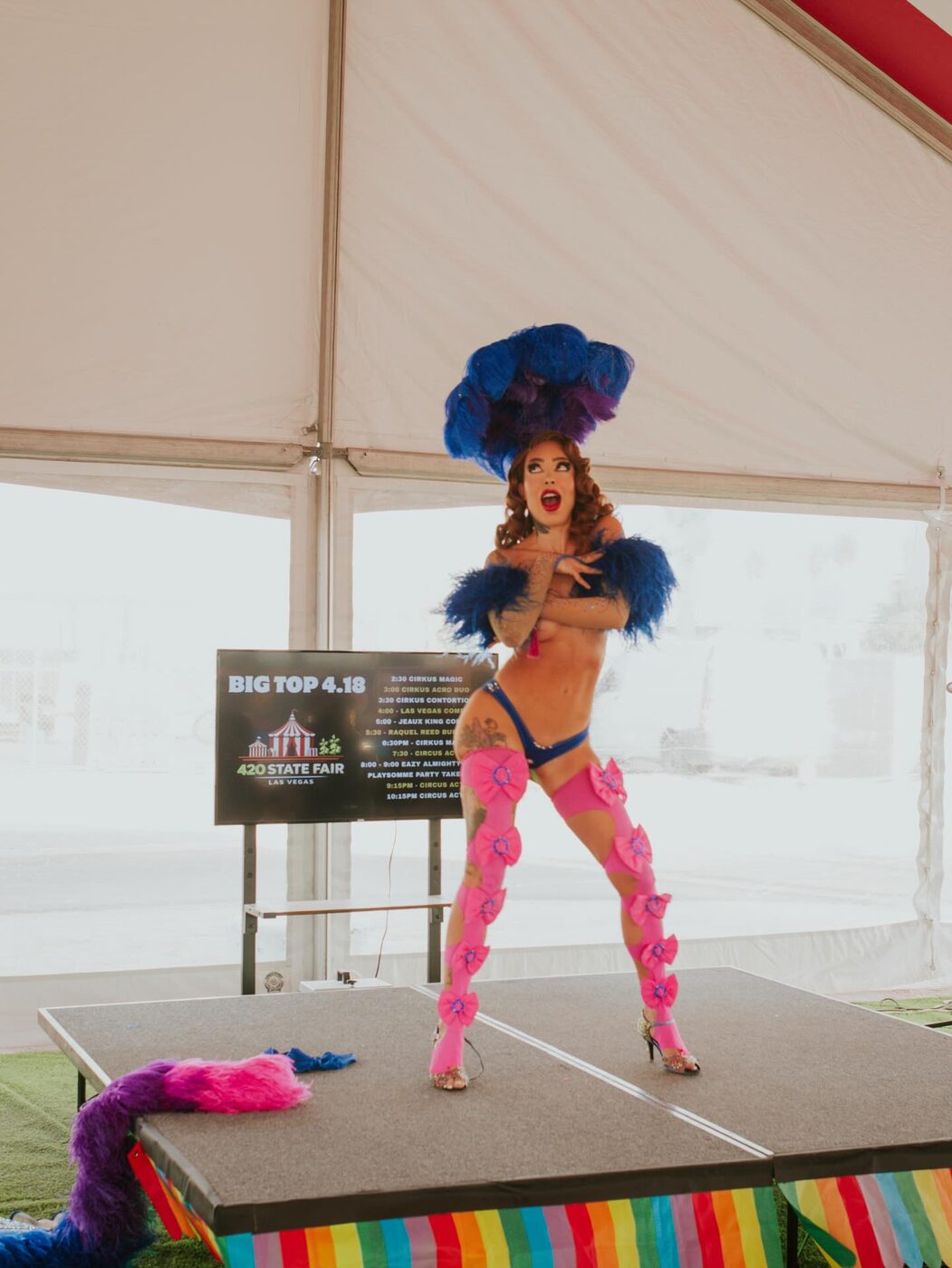 A neon-lit performer at the fair stage