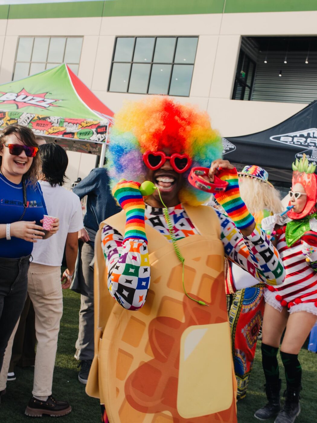 Friends in rainbow costumes and wigs