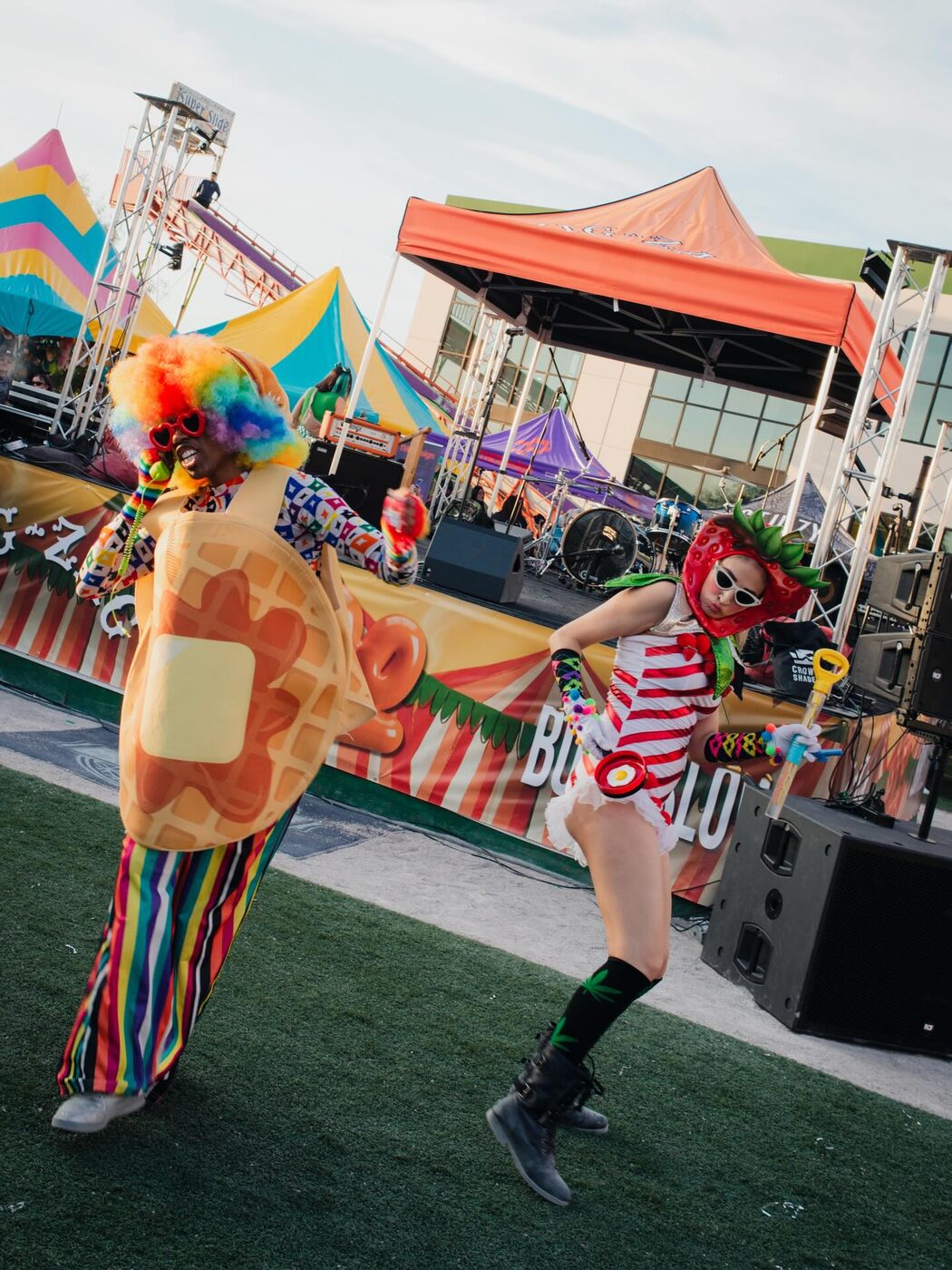 A performer commands the main stage in magenta light