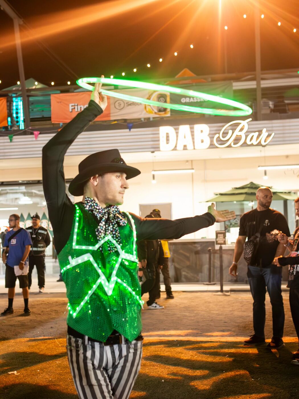 An LED-suit performer hypes the rooftop dab bar
