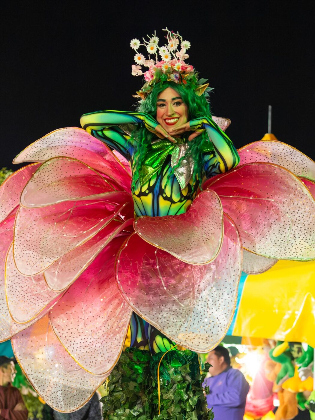 A performer in an elaborate flower-petal costume