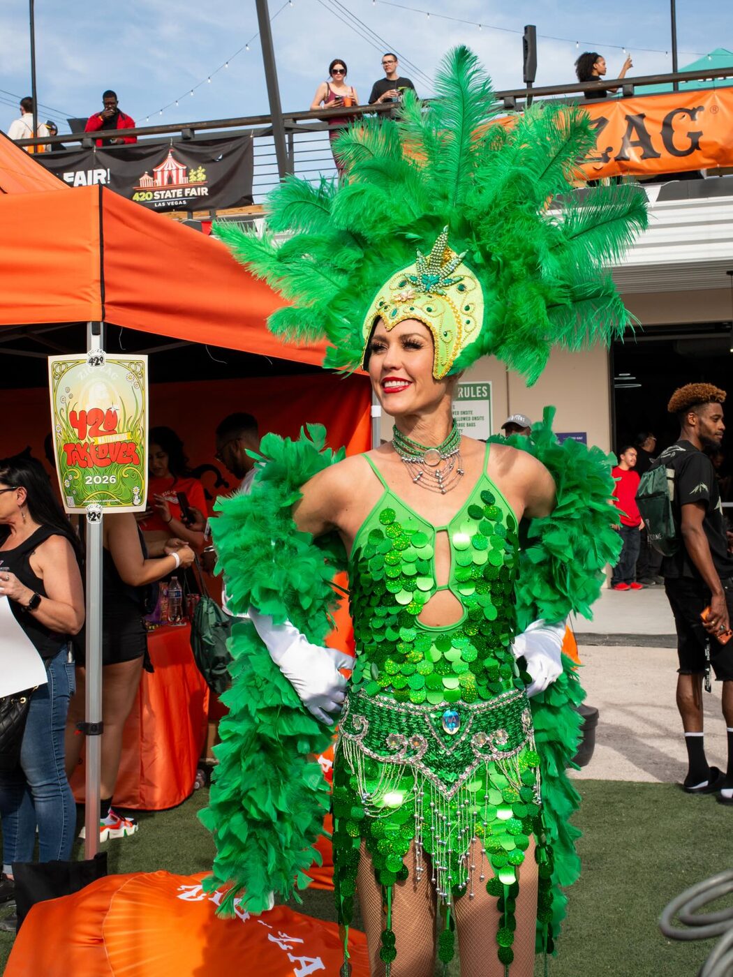 A green-feathered showgirl dancer