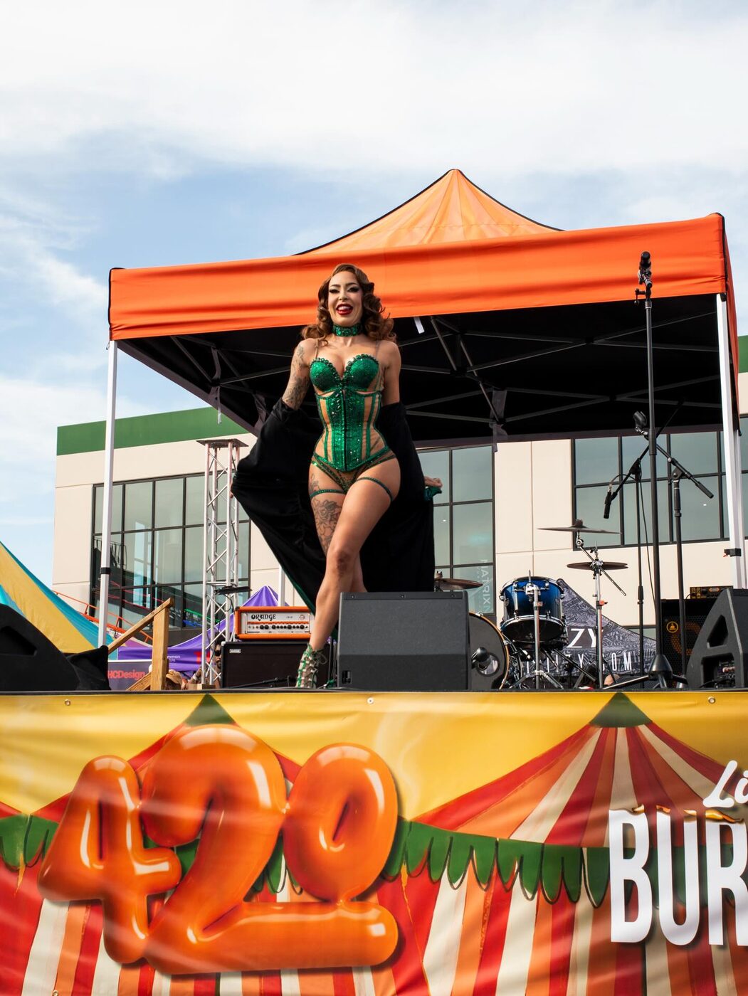 A performer in a green corset on the main stage